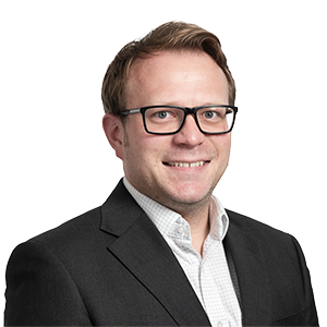 Man in glasses, black blazer and white shirt