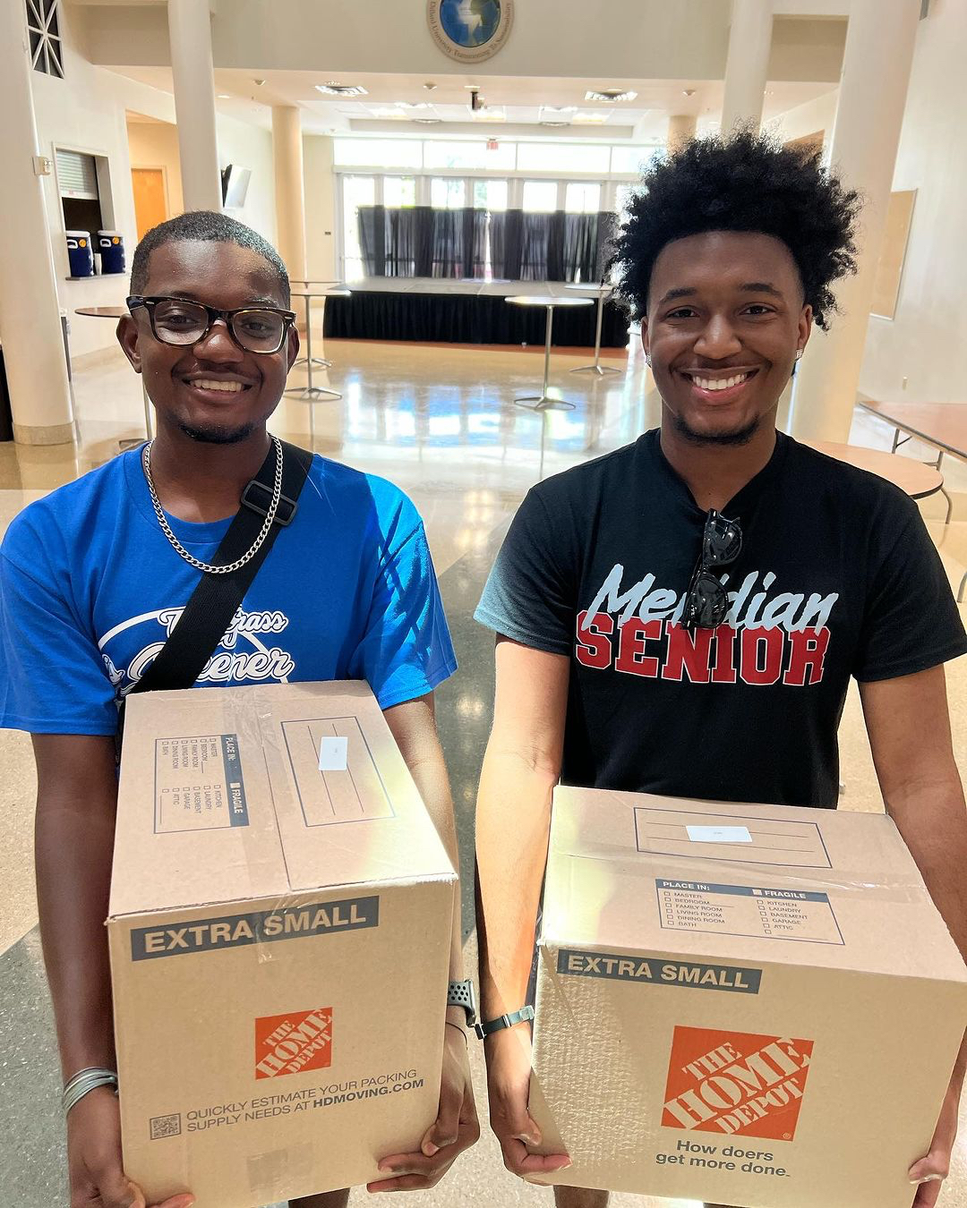 Two students carry packages.