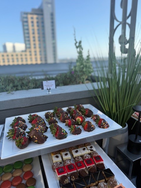 Chocolate-covered strawberries, macaroons and other sweets.