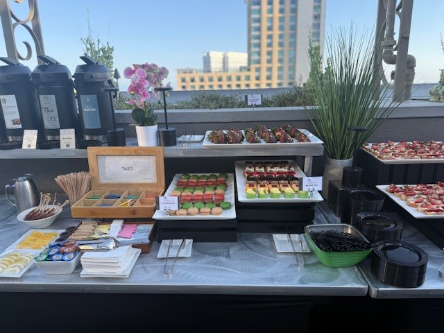 An array of teas, pastries and chocolate covered strawberries at the event.