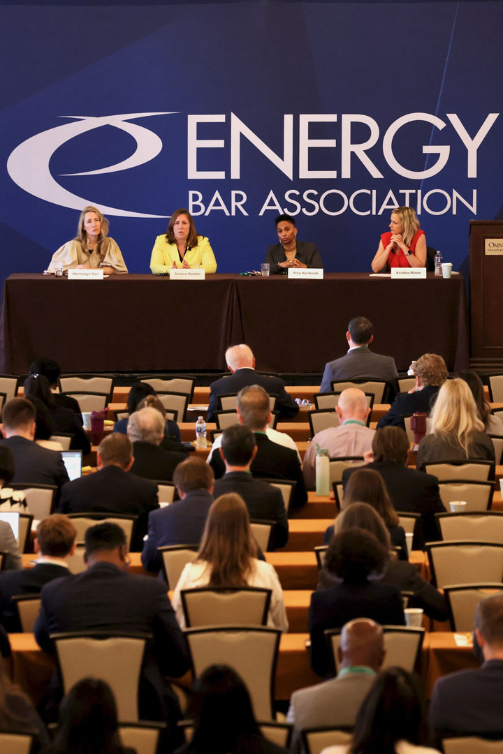 Kristina Moore and panelists speak to a crowd at the Energy Bar Association