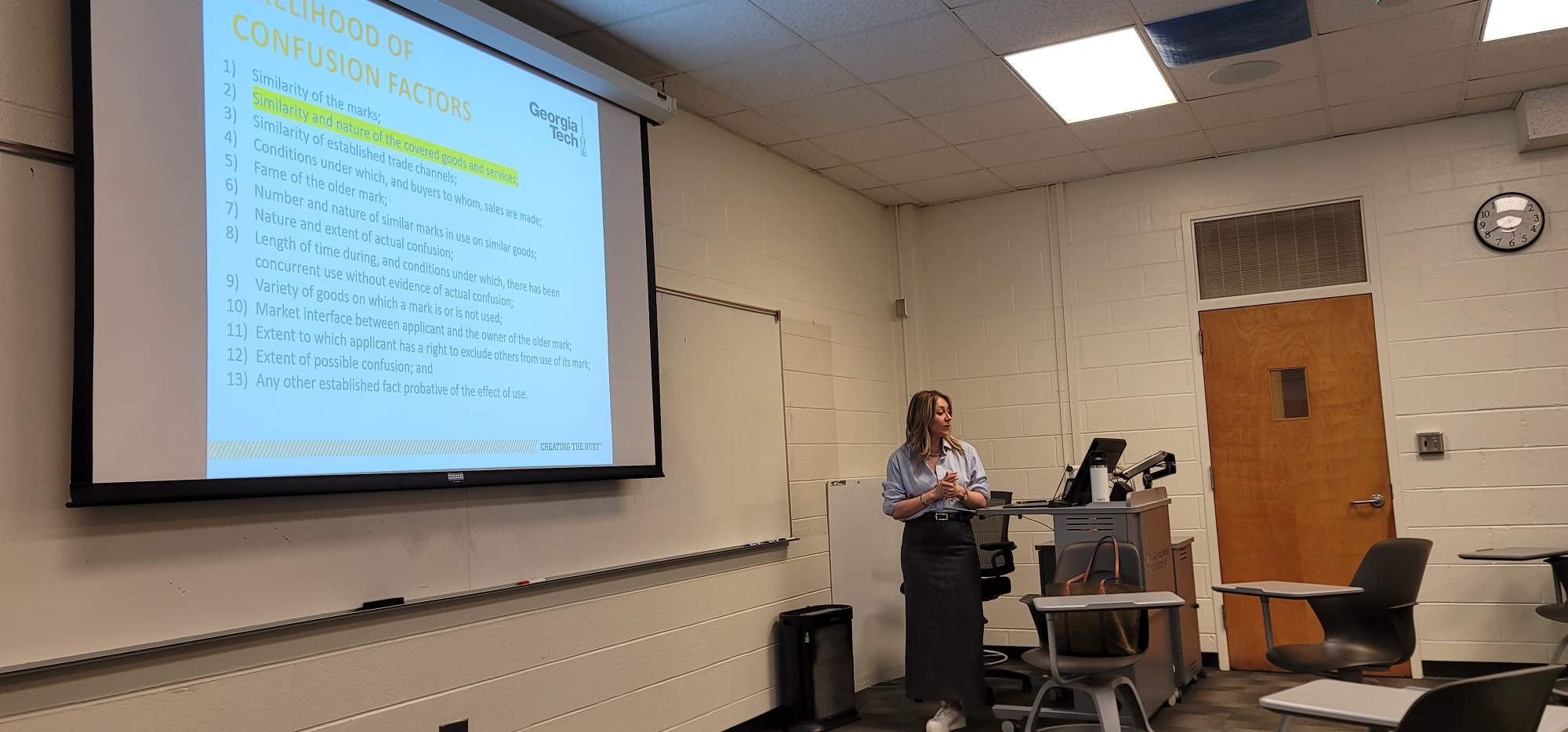 Kate Johnson speaks to the class. A powerpoint slide titled "Likelihood of Confusion factors" with the Georgia Tech logo is displayed.