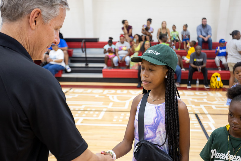WBD Partner Chris Geis shakes hands with tee ball participants at the closing ceremony.