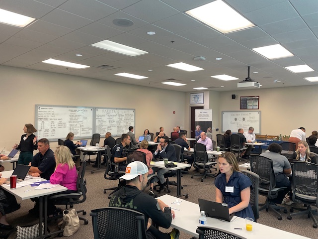 First responders and attorneys sit in a large room at the Charlotte Police & Fire Training Academy.