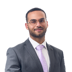 Man in grey suit jacket, white shirt and lilac tie