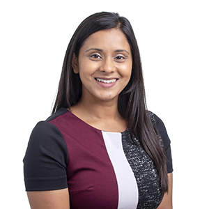 Professional young woman smiling in business attire with white background.