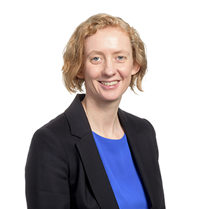 Professional woman wearing business attire in a corporate headshot.