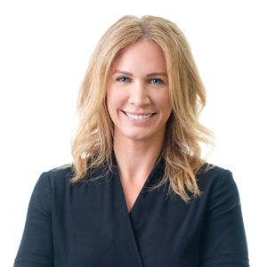 Professional woman with blonde hair smiling in black business attire against a white background.