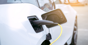 Electric car parked at a charging station - Shutterstock 666353437