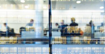 Reflection of people working in office