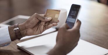 Man making payment on phone using his credit card