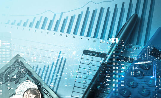 A city view is in the background of a business overlay, showing reports with charts, a pen, and cash.