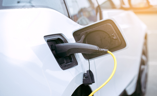Electric car parked at a charging station - Shutterstock 666353437
