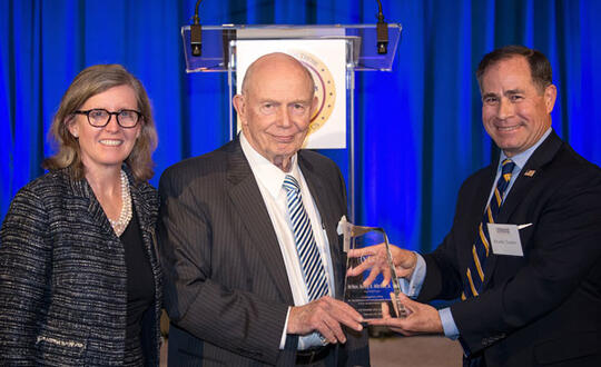 Womble Bond Dickinson Partner Beth Tyner Jones and Brooks Tucker stand with former NC Supreme Court Chief Justice Burley Mitchell as he receives the Veterans Life Center of North Carolina's Lifetime Achievement Award. Photo Credit: Jeff Hyde at Aesthetic Images Photography