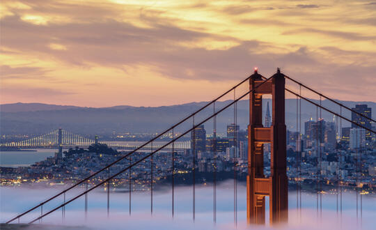 Fog rolls beside the Golden Gate Bridge in San Francisco, California.