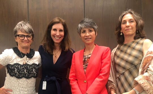 The panelists are standing in a line and smiling: Susan Knight, 50/50 Women on Boards Houston Founder & Chair; Betty Temple, Chair & CEO of Womble Bond Dickinson; Victoria Lazar, TechnipFMC Executive VP, Chief Legal Officer & Secretary; and Duy-Loan Le, a Board of Directors member for Wolfspeed, National Instruments, Ballard Power Systems and Atomera.