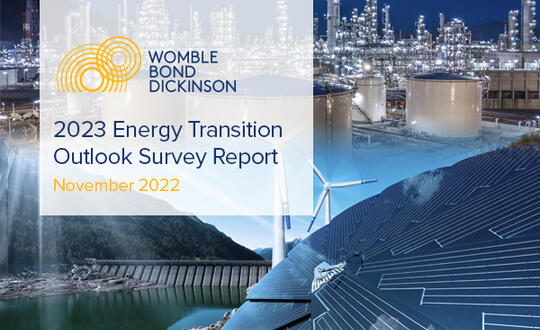 The highlighted text reads, "Womble Bond Dickinson 2023 Energy Transition Outlook Survey Report - November 2022." The background displays a variety of energy sources, signifying the transition from more traditional sources like oil and gas to "greener" sources such as hydrogen and solar.