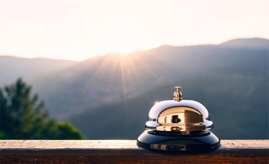 A bell sits on the ledge of a deck. (Source: Getty Images)