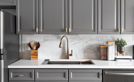 Kitchen with gray cabinets and white counterspace