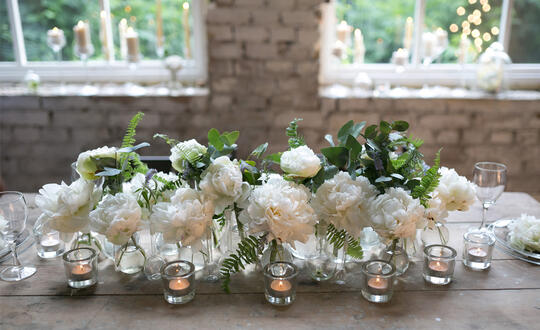 Flowers and candles on a table at a wedding