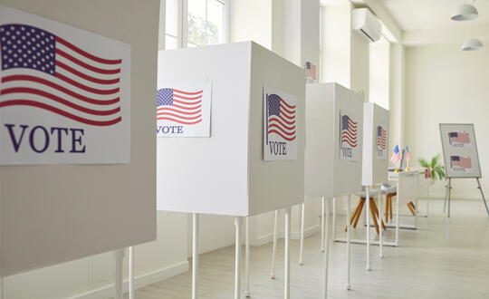 Ballot boxes in an empty, white room