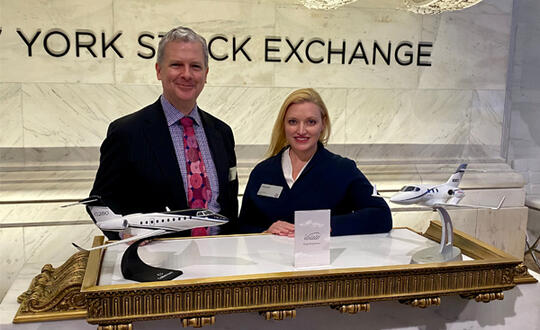 Reid Avett and Laura Kees behind a Volato display at the New York Stock Exchange