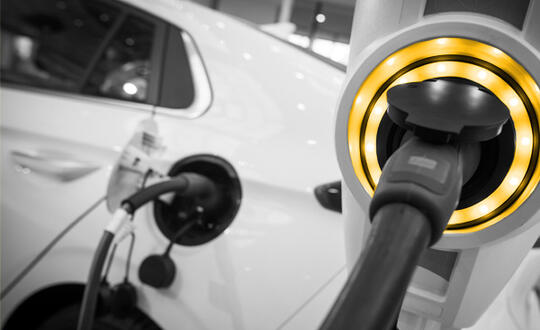 An electric vehicle plugged into a charging station