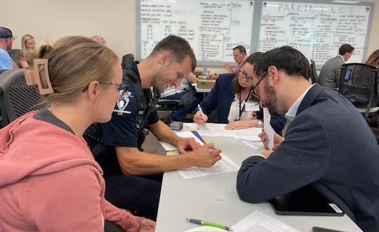 A Charlotte-Mecklenburg police officer completes paperwork at the Wills for Heroes program.