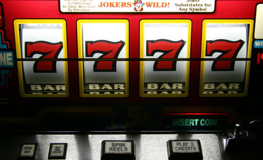 Slot machine with four 7's across the top