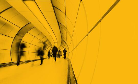 Blurred people walking through a passenger tunnel