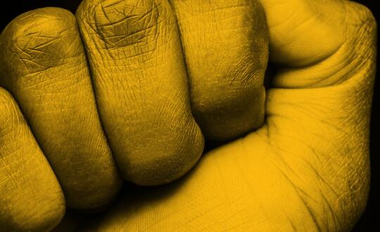 Close up of person clenching fist in palm