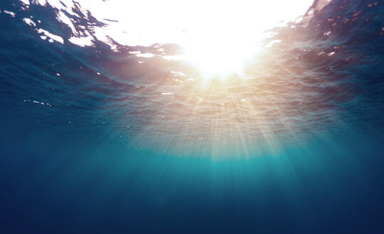 Sun streaming through deep water