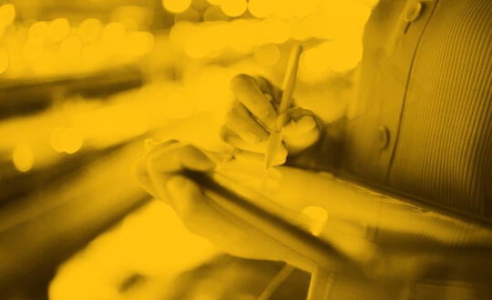 Person holding tablet with pen