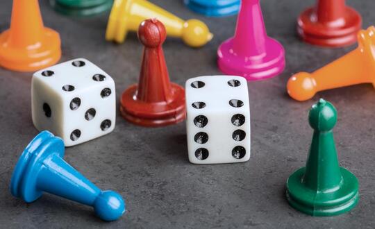 Dice and board game pieces.
