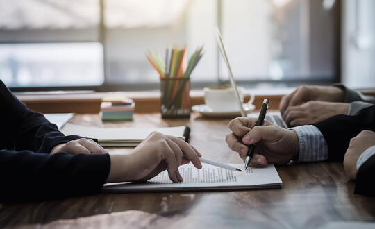 People signing paperwork contract