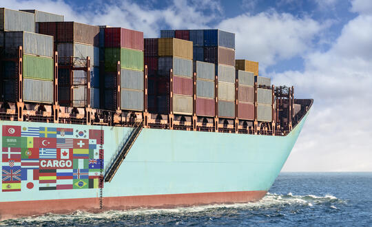 Cargo ship loaded with colourful containers at sea, demonstrating international maritime freight transport.