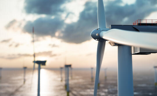 Wind farms showing a sunset sky in the horizon
