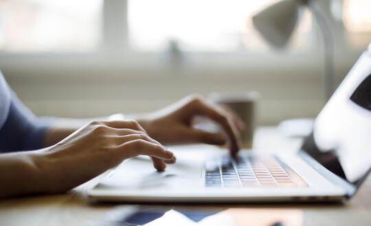 Person typing on laptop