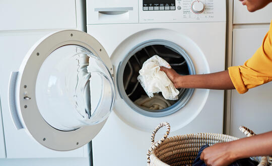 Woman loading washing machine 