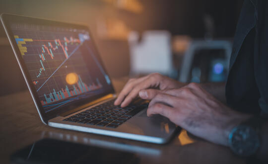 Person on laptop looking at financial figures