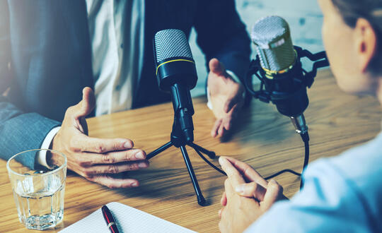 Two people recording a podcast
