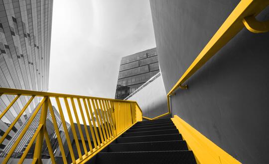 Upwards shot of staircase, surrounded by commercial buildings