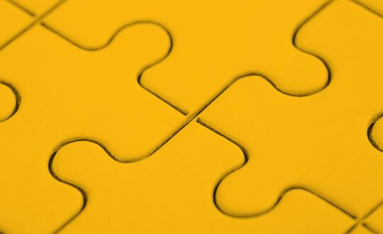 Close up of jigsaw pieces in yellow