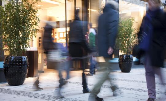 People walking in front of shop