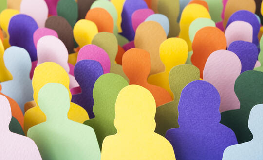 Silhouettes of people cut out of colourful paper