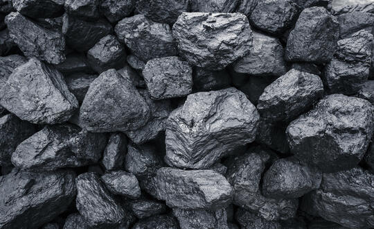 Close-up of anthracite coal pieces, high-quality coal, black coal chunks for fuel, carbon-rich mineral, black rock texture, coal mining background.