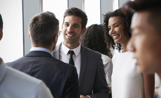 Business professionals networking and engaging in conversation at a corporate event