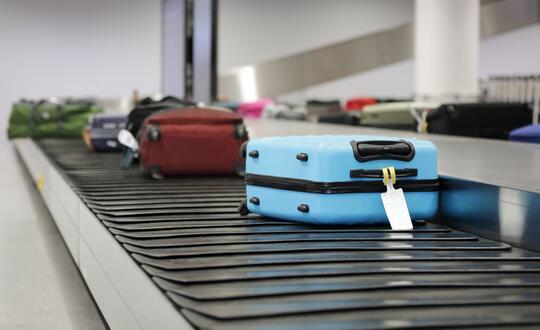 Suitcases on conveyor belt at airport