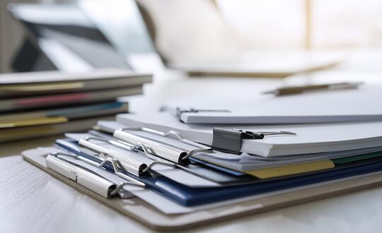 Pile of contracts and forms on clipboards