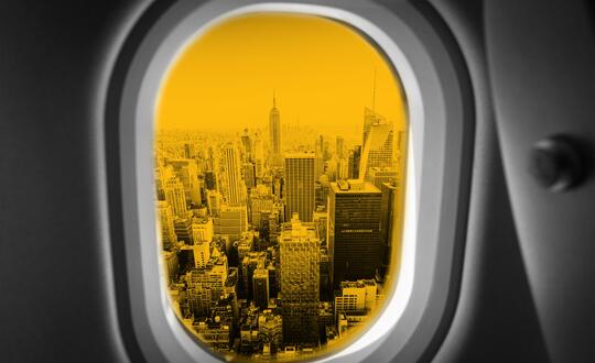 Plane window overlooking cityscape